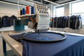 Commercial embroidery machine stitching a logo